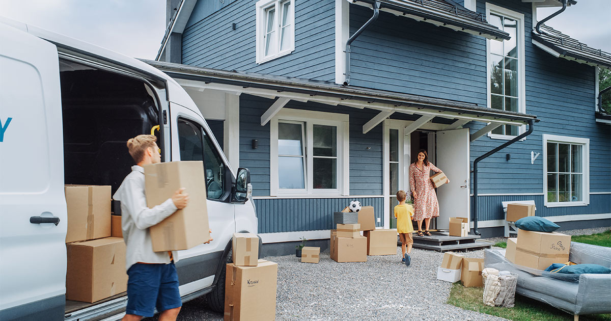 A family of three arrives at their new home after a long distance move. They booked the long distance move several months in advance, as soon as they knew they were moving. 